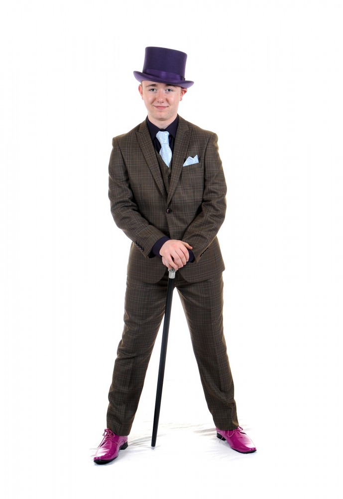 Student in a purple three-piece suit with a cane, posing in the prom studio